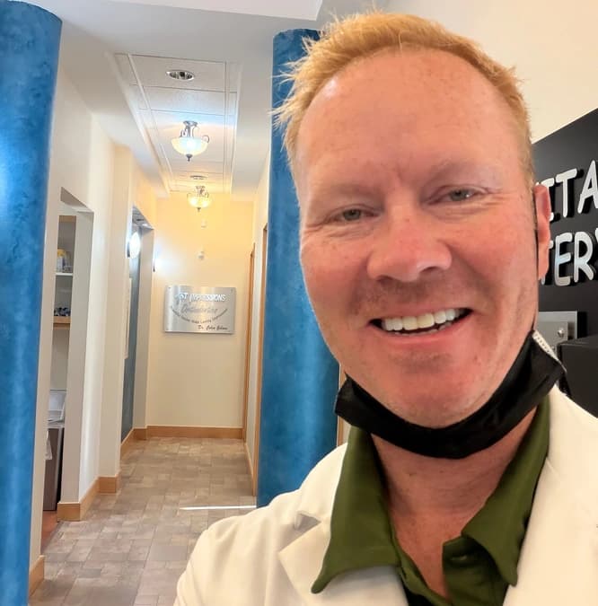 Dr. Colin Gibson smiling in the 1st Impressions Orthodontics hallway