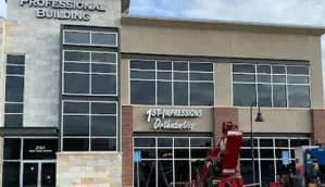 The building entrance with the 1st Impressions Orthodontics sign